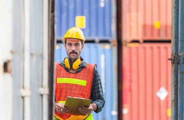 Worker man holding clipboard checklist and checking containers box from cargo
