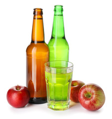 Bottles and glass of apple cider on white background