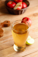Glass of fresh apple cider on table