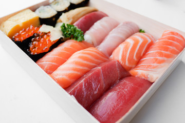 Various kinds of fresh sushi set in wooden box