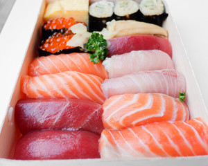 Various kinds of fresh sushi set in wooden box