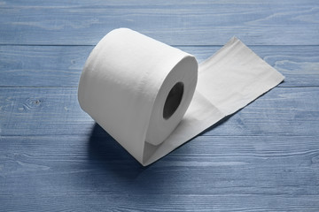 Roll of toilet paper on wooden background