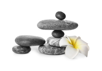 Fototapeta na wymiar Stack of zen stones and flower on white background