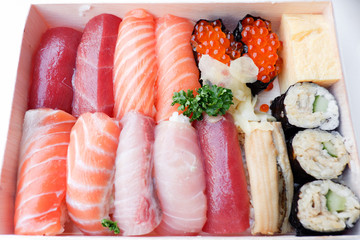 Various kinds of fresh sushi set in wooden box