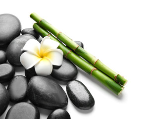 Spa stones, flower and bamboo on white background