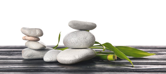 Fototapeta na wymiar Zen stones and bamboo on table against white background