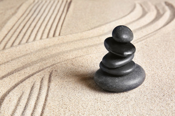 Fototapeta na wymiar Stones on sand with lines. Zen concept
