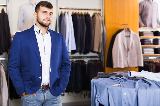Brunette male customer choosing jacket