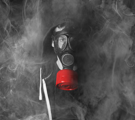 Man in a gas mask in the smoke
