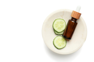 Bottle of cosmetics with cucumber extract on white background