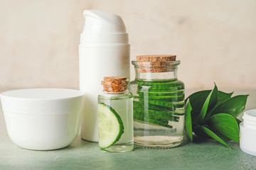 Obraz na płótnie Canvas Cosmetics with cucumber extract on table