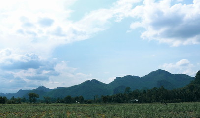 Fototapeta premium Views of mountains, fields and clouds sky