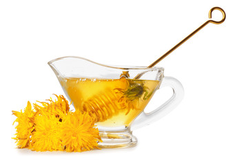 Gravy-boat of sweet dandelion honey on white background