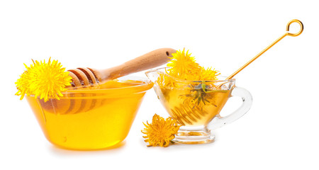 Glassware of sweet dandelion honey on white background