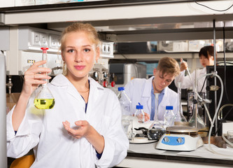 Female scientist holding flask