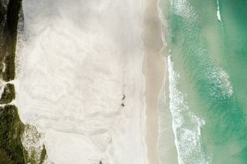aerial zenithal photo of beach with blue-green sea