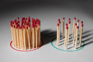 Groups of matches on light background. Concept of social distance