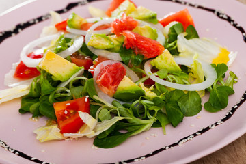 Salad of  avocado, tomatoes, grapefruit and corn salad at plate