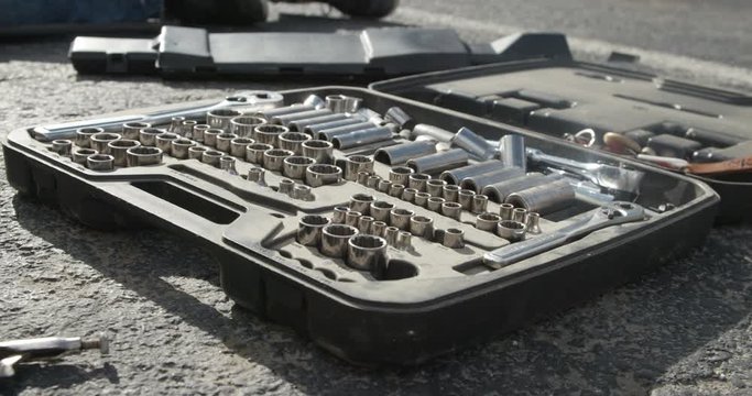 Tool kit laid out on the road slow motion cinematic