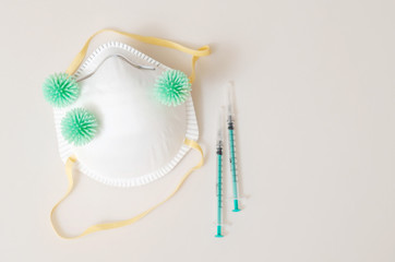 virus bacteria on medical mask with syringes on table