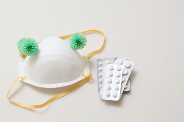 virus bacteria on medical mask with tablets pills on the table