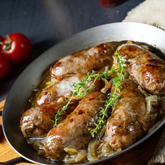 Homemade white sausage fried with onion and herbs
