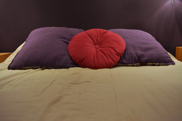 Bed with violet and pink pillows
