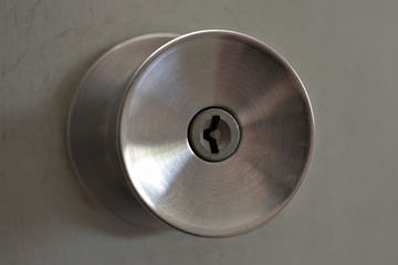 a metal door knob with key lock