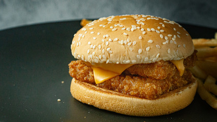 double burger fish on black plate for food content.