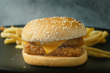 double burger fish on black plate for food content.