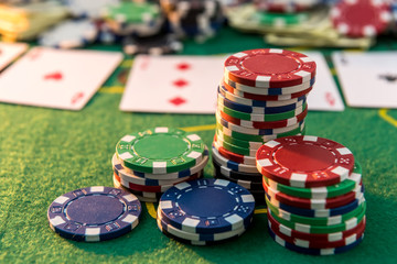 view of a gaming table with many poker card and chips green mat