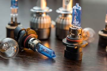 Various Car electric bulbs for parts in headlight on  dark background. many new 12v car filament...