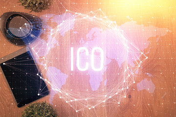 Double exposure of blockchain theme hologram over table with phone. Top view. Crypto technology...