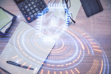 Double exposure of data drawing hologram over topview of study desk background with computer. Concept of Ai.