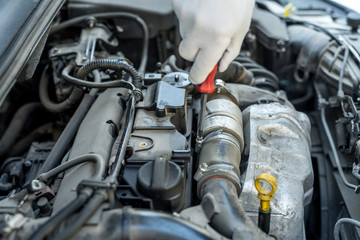 Fototapeta na wymiar mechanic's hand with screwdriver repair or check car in garage