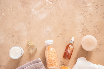 Sea salt, natural essential oils, aroma candle  and towel on beige background for spa time and relax concept. Salon or home beauty treatments.