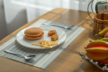 Hamburger with french fries on the table, junk food concept