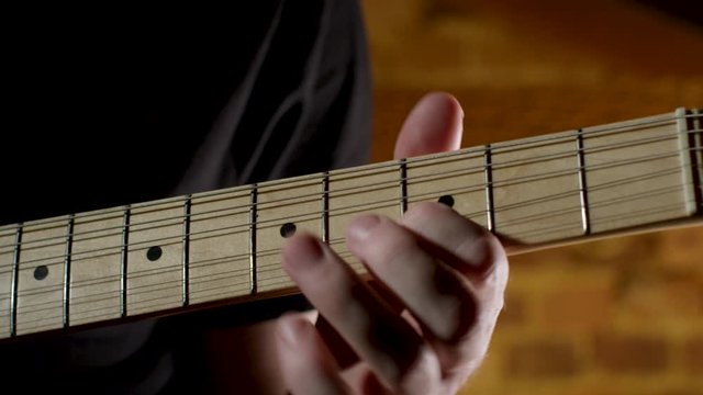 Guitar player plays solo on electric guitar using simple pentatonic scale