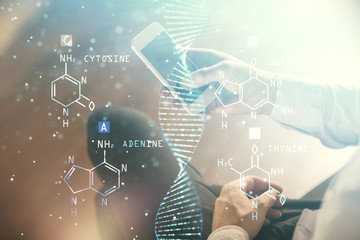 Double exposure of man's hands holding and using a phone and DNA drawing. Medical education concept.