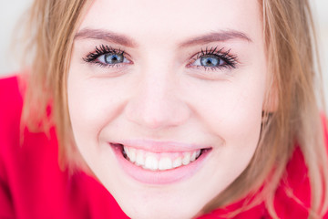 Smiling woman. Beuty face. Close-up beauty face of young beutiful model woman touching face healthy skin. Natural lips, makeup.