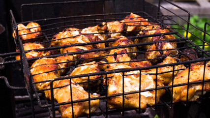 Chunks of chicken are grilled on a grill. Pickled kebab. Rest at nature. Barbecue with family. Weekend at the cottage.