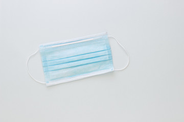 Blue medical mask to protect your health from the virus on a grey background