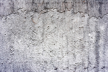 Texture of a concrete wall with cracks and scratches which can be used as a background