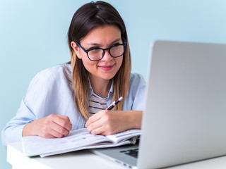 Distance learning online education. Woman studying with laptop, watching webinar