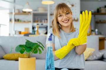 Young attractive woman cleaning home. Young beautiful woman at home.