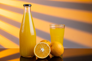 bottle of orange juice and oranges