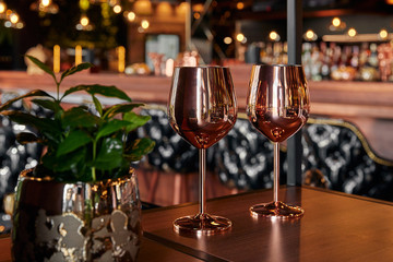 gold metal wine glass, dark background