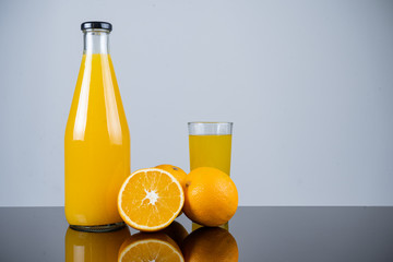 Bottle of orange juice and oranges