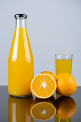Bottle of orange juice and oranges