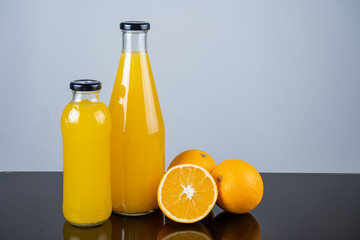 Bottle of orange juice and oranges